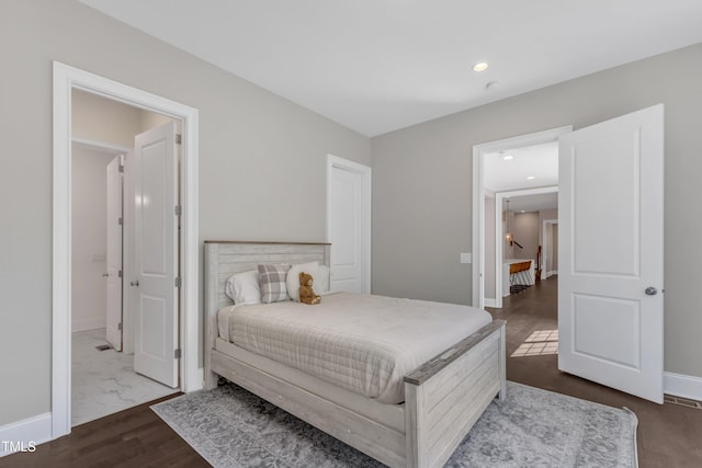 bedroom featuring recessed lighting, baseboards, and dark wood-type flooring