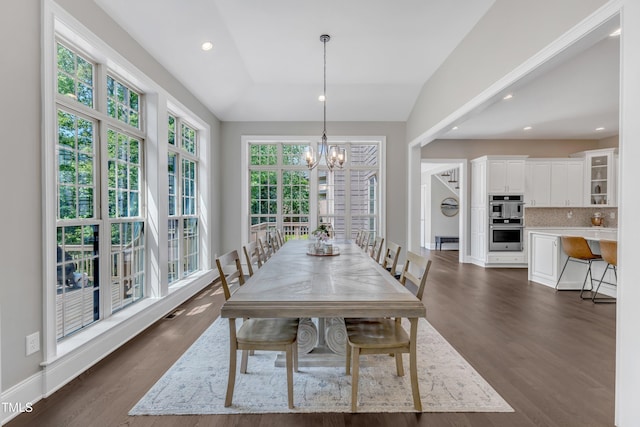 dining space featuring visible vents, vaulted ceiling, dark wood-style floors, an inviting chandelier, and recessed lighting