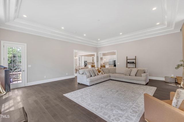living area with a raised ceiling, baseboards, ornamental molding, recessed lighting, and dark wood-type flooring