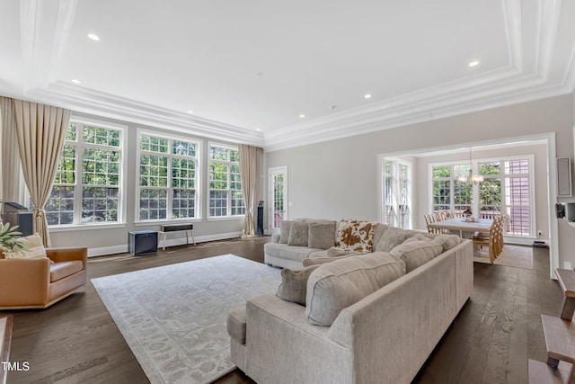living room featuring crown molding, dark wood-type flooring, recessed lighting, and a notable chandelier
