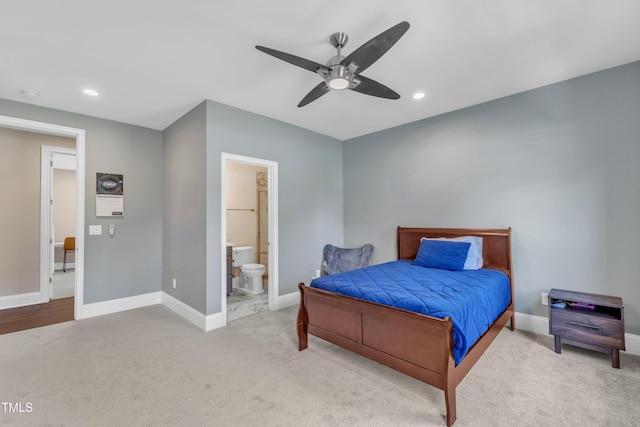 carpeted bedroom with baseboards, recessed lighting, and connected bathroom