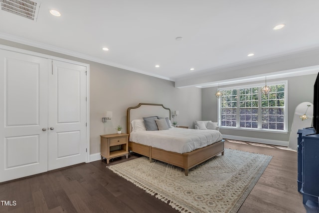 bedroom featuring crown molding, baseboards, dark wood-style flooring, and visible vents
