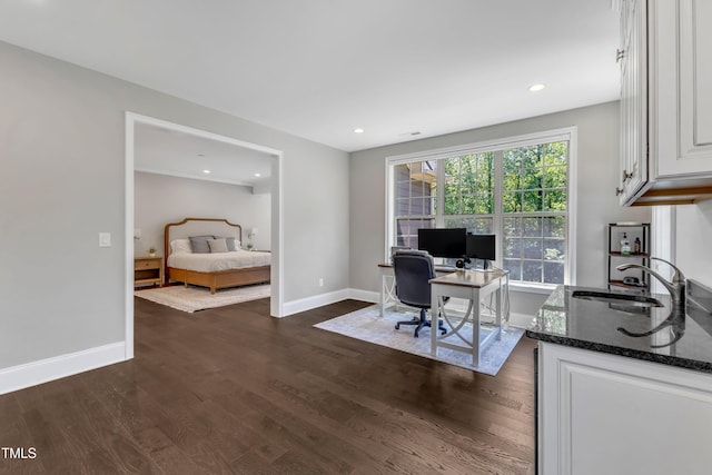 office space featuring baseboards, dark wood-style floors, and a sink