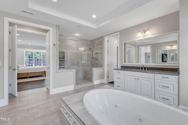 ensuite bathroom featuring a jetted tub, baseboards, ensuite bathroom, visible vents, and a stall shower