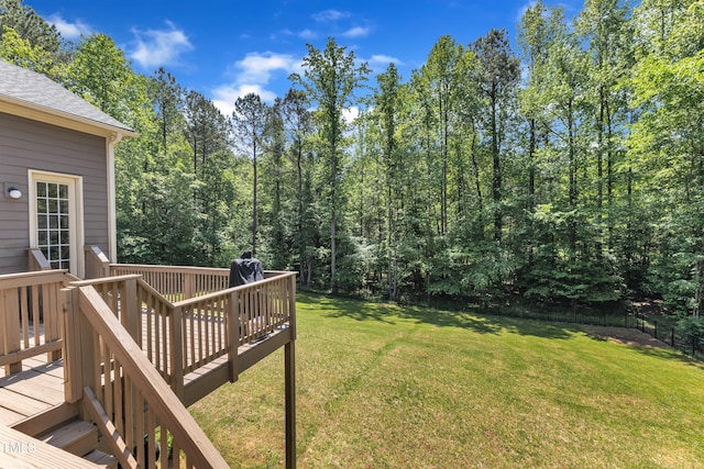 view of yard with a wooden deck and fence