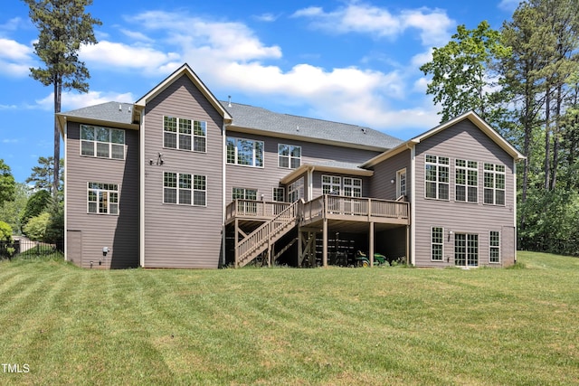 back of property with a lawn, stairway, and a deck