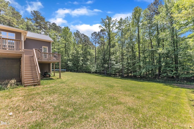 view of yard with a wooden deck and stairs