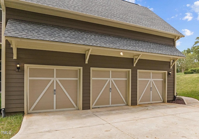 view of outbuilding featuring a garage and driveway