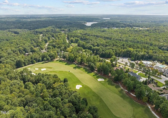 drone / aerial view with a view of trees and view of golf course