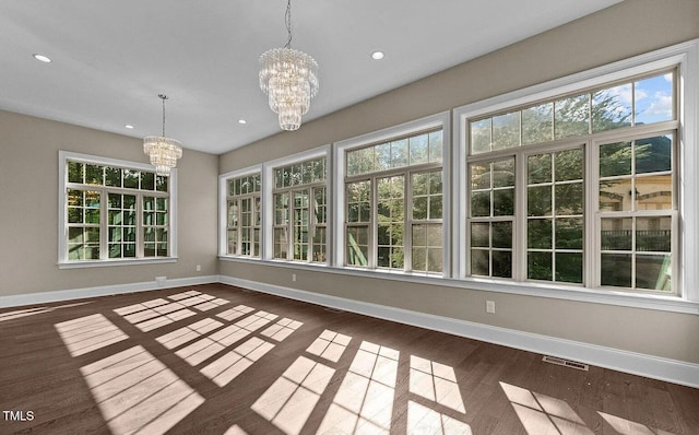 unfurnished sunroom featuring a notable chandelier, a wealth of natural light, and visible vents