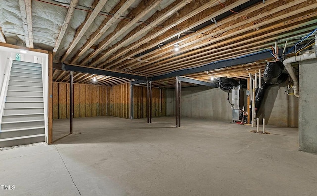 unfinished below grade area with stairs and heating unit
