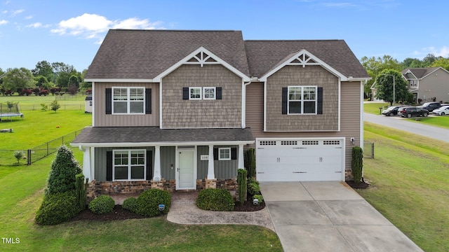 craftsman-style house featuring driveway, roof with shingles, a garage, fence, and a front lawn