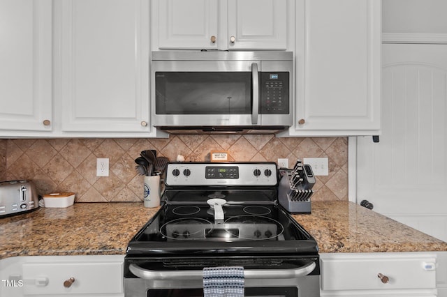 kitchen featuring stone countertops, tasteful backsplash, white cabinets, and stainless steel appliances