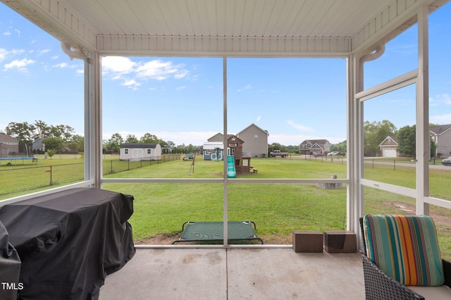 sunroom featuring a residential view