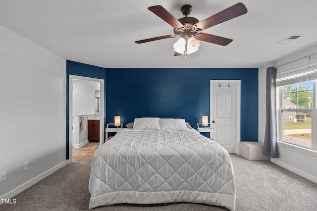 bedroom featuring baseboards, visible vents, a ceiling fan, and light colored carpet