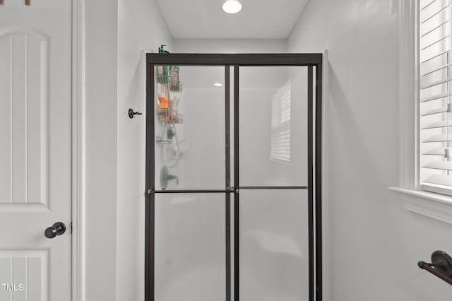 bathroom featuring recessed lighting and a shower stall
