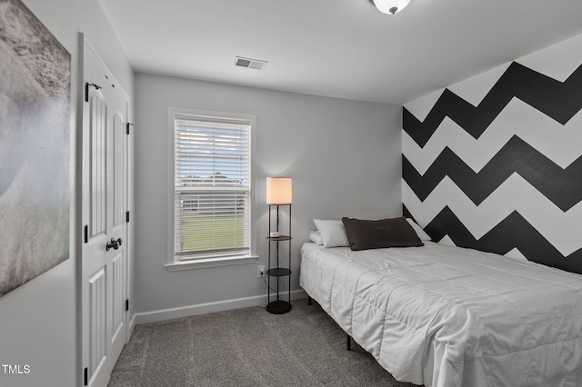 carpeted bedroom featuring baseboards and visible vents