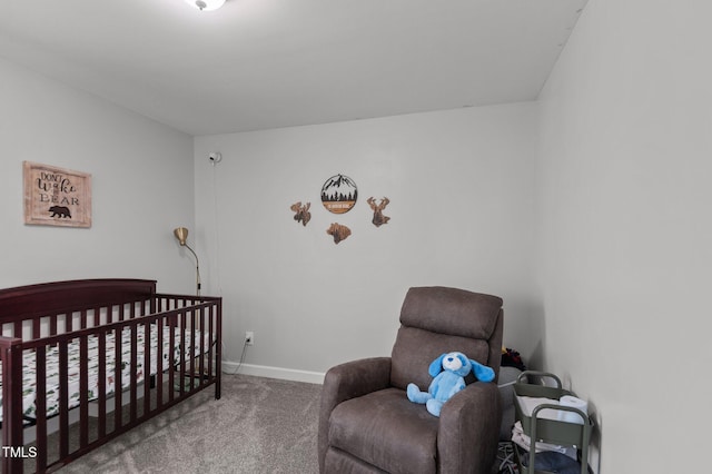bedroom with baseboards, carpet, and a nursery area