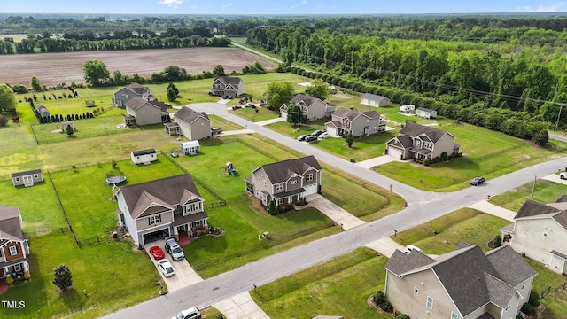 bird's eye view featuring a residential view and a wooded view