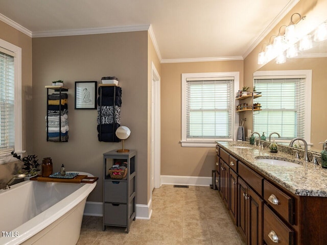full bathroom with a sink, baseboards, ornamental molding, and a soaking tub