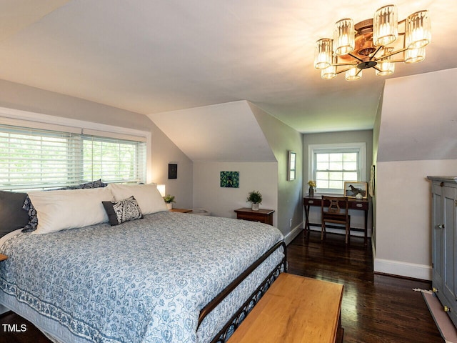 bedroom with baseboards, multiple windows, and wood finished floors