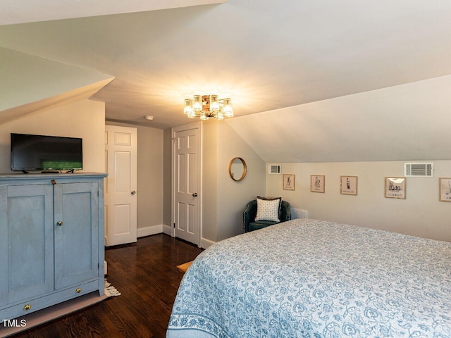 bedroom featuring an inviting chandelier, baseboards, vaulted ceiling, dark wood-type flooring, and visible vents