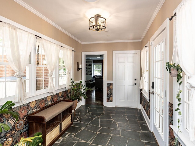 foyer featuring a chandelier, stone finish flooring, and ornamental molding