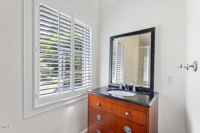 bathroom with vanity, crown molding, and a shower