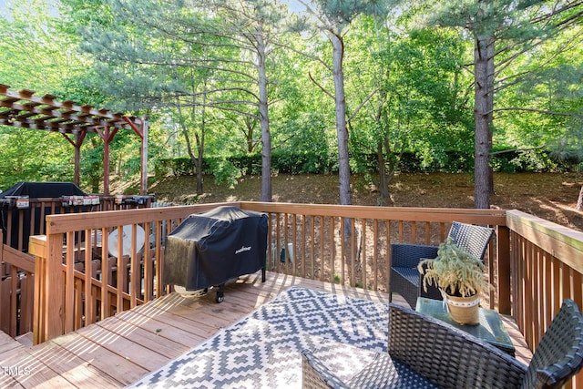 wooden deck featuring a pergola and grilling area
