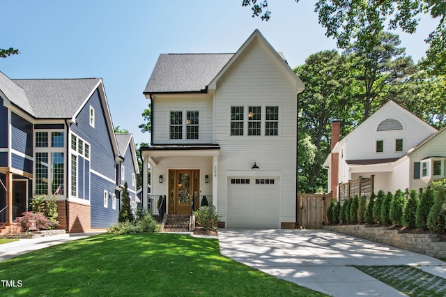 view of front facade with a garage, a front lawn, fence, and driveway