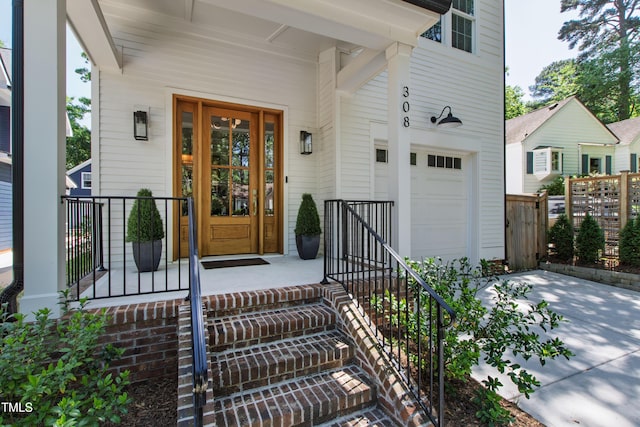 property entrance featuring a garage and fence