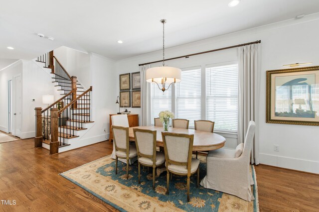 dining room with stairs, recessed lighting, baseboards, and wood finished floors