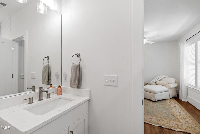 bathroom featuring vanity, a ceiling fan, wood finished floors, and visible vents