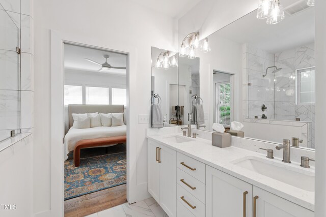 bathroom with visible vents, tiled shower, a sink, and marble finish floor