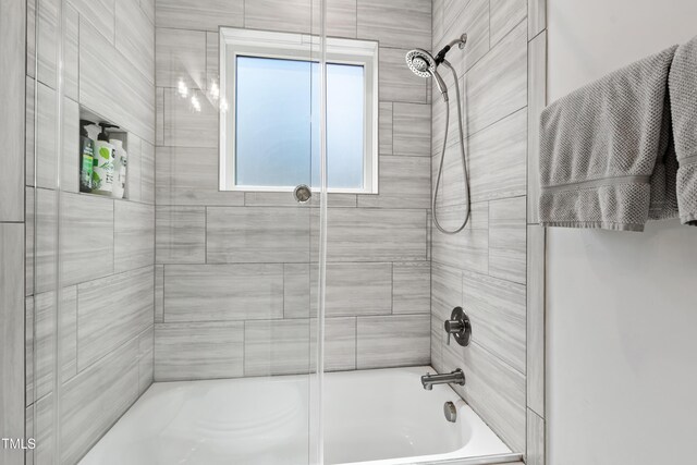 full bath featuring combined bath / shower with glass door