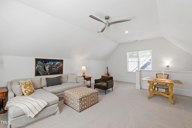 living area featuring baseboards, carpet, a ceiling fan, and lofted ceiling