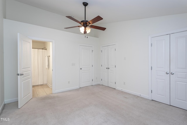 8719 Cypress Grove Run, Raleigh, NC 27612 - unfurnished bedroom featuring baseboards, ensuite bathroom, two closets, and light carpet