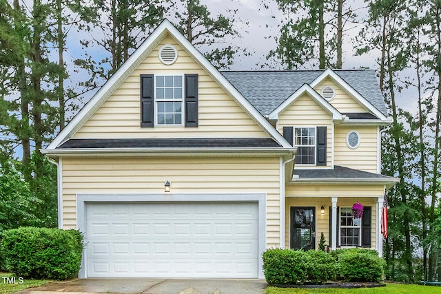 1984 Sadler Ave, Creedmoor, NC 27522 - traditional home featuring concrete driveway, roof with shingles, an attached garage, and covered porch