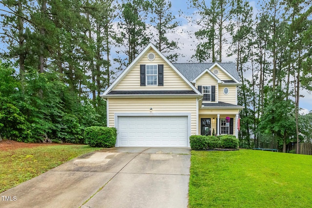 1984 Sadler Ave, Creedmoor, NC 27522 - traditional home with concrete driveway, a front yard, an attached garage, and a shingled roof