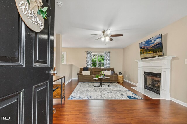 1984 Sadler Ave, Creedmoor, NC 27522 - living room with a ceiling fan, a fireplace with flush hearth, wood finished floors, and baseboards