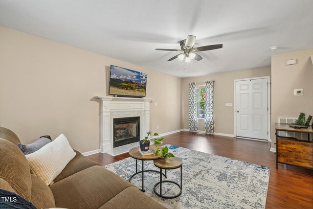1984 Sadler Ave, Creedmoor, NC 27522 - living area with a ceiling fan, dark wood-style floors, baseboards, and a high end fireplace