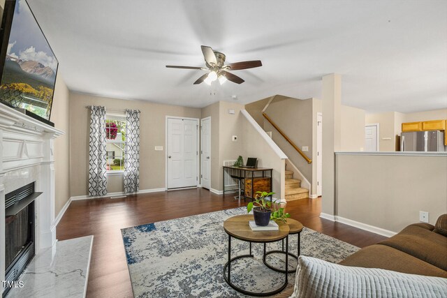 1984 Sadler Ave, Creedmoor, NC 27522 - living room with ceiling fan, wood finished floors, stairs, and a high end fireplace