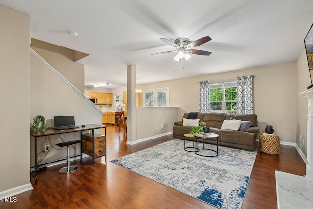 1984 Sadler Ave, Creedmoor, NC 27522 - living area with ceiling fan, dark wood finished floors, baseboards, and a high end fireplace