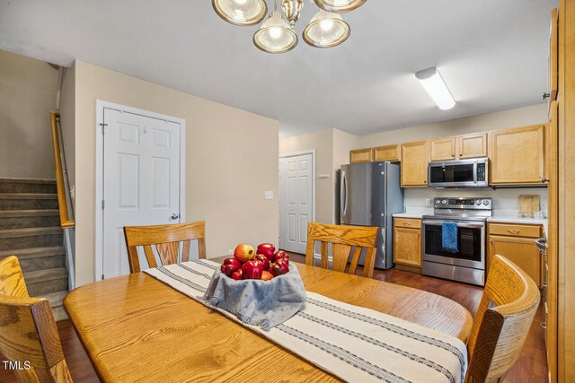 1984 Sadler Ave, Creedmoor, NC 27522 - dining room with a chandelier, stairs, and dark wood-type flooring