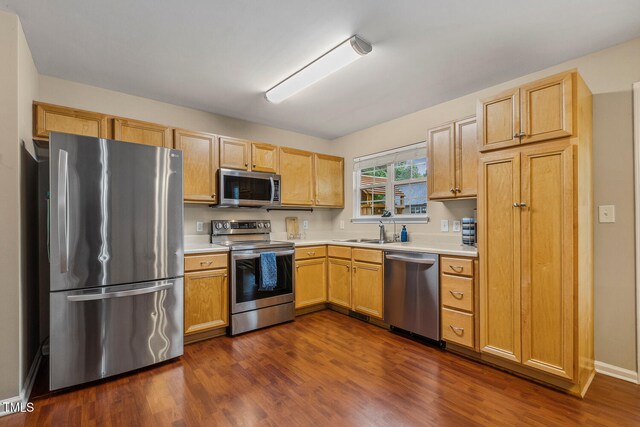 1984 Sadler Ave, Creedmoor, NC 27522 - kitchen featuring stainless steel appliances, light countertops, dark wood-style floors, and a sink