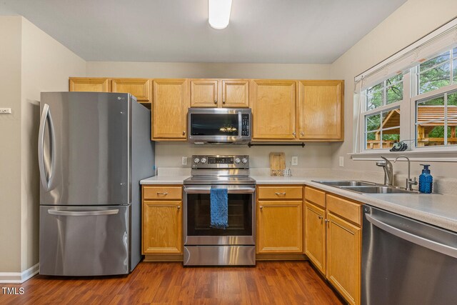 1984 Sadler Ave, Creedmoor, NC 27522 - kitchen with stainless steel appliances, a sink, light countertops, and dark wood-type flooring