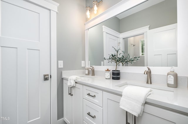bathroom with double vanity, a sink, and walk in shower
