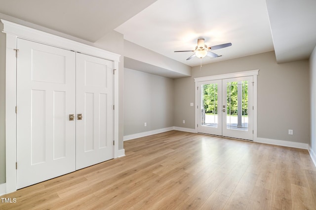 unfurnished bedroom featuring access to outside, baseboards, and light wood-style floors