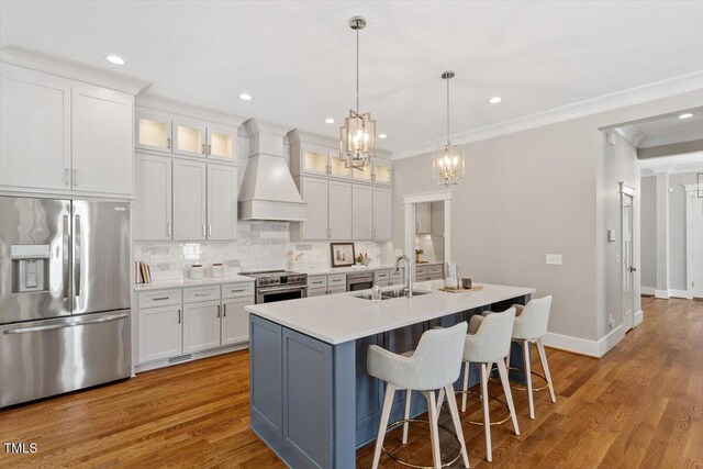 3932 Old Chapel Hill Rd, Durham, NC 27707 - kitchen featuring a sink, stainless steel appliances, a breakfast bar area, an inviting chandelier, and custom range hood