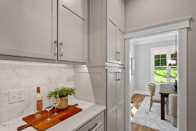 3932 Old Chapel Hill Rd, Durham, NC 27707 - kitchen featuring backsplash, light countertops, baseboards, and light wood-style floors